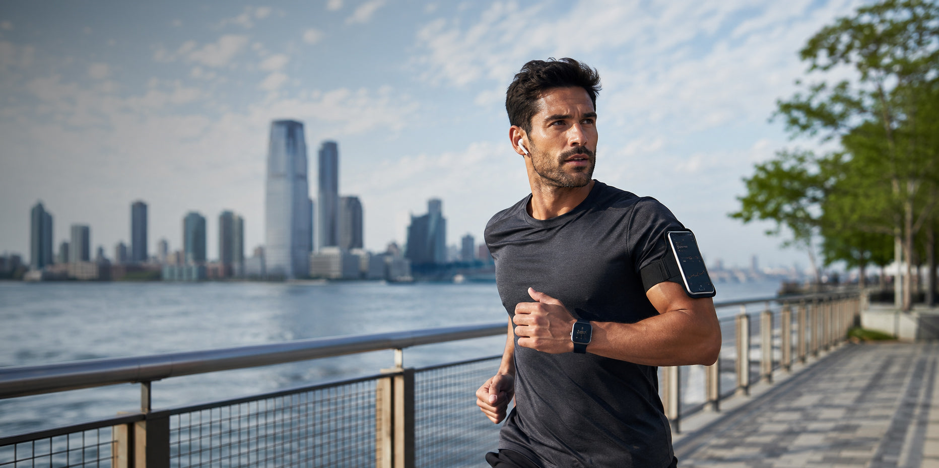 Man running by a waterfront with a city skyline in the background